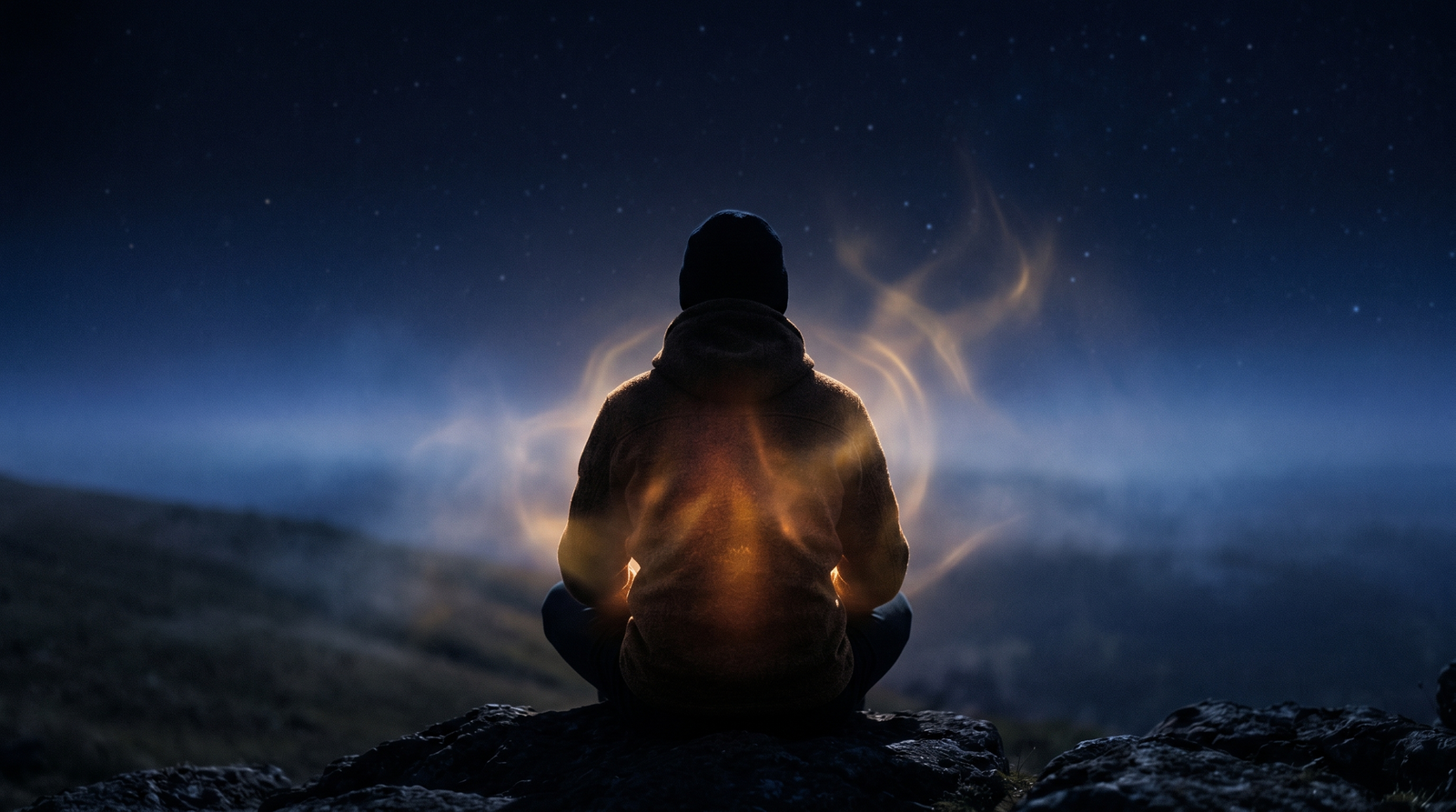 Silhouette emanating warm light in darkness—a poetic visualization of the mind processing and understanding fear.